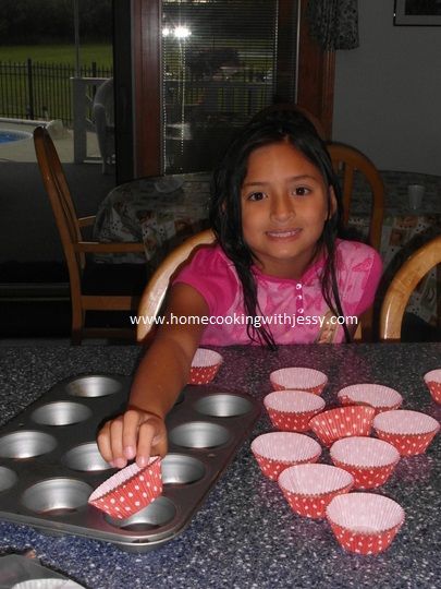 While Mommy is heating up the oven to 350 degrees, I put the cups to the baking tins